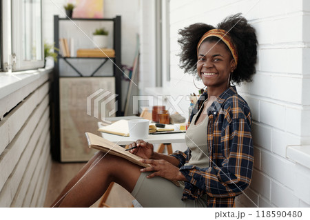 Smiling Artist Working on Art Project in Studio 118590480