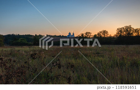 Rural landscape with a church on the background of sunset Rural landscape with a church on the background of sunset 118591651