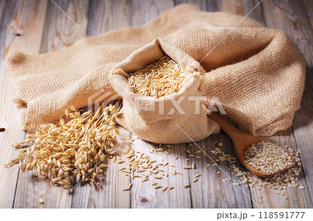 grains of oats, oatmeal and oats spikelets on wooden background 118591777