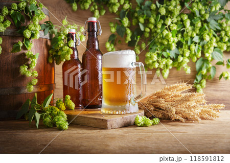 mugs of beer, green hops, bottles, wheat ears and beer barrel mugs of beer, green hops, bottles, wheat ears and beer barrel 118591812