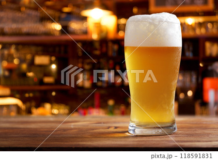 glass of beer in a bar on wooden counter glass of beer in a bar on wooden counter 118591831