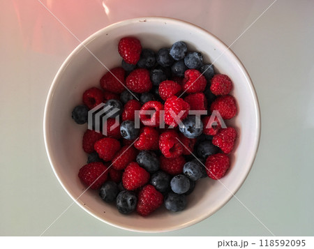 Close-up tasty ripe fresh summer berries - raspberry and blueberry Close-up tasty ripe fresh summer berries - raspberry and blueberry 118592095