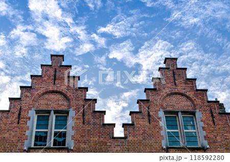 Bruges, Belgium; view of the medieval buildings that are crossed by the canals of the city. Historic center World Heritage	 118592280