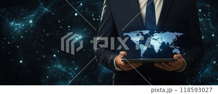 Businessman in a suit holding a tablet with a digital world map, symbolizing global connections and technology in a corporate setting 118593027