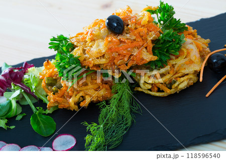 Tasty fried carrots cutlets with greens served at plate on table Tasty fried carrots cutlets with greens served at plate on table 118596540