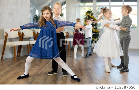 Tween boy and girl performing waltz during Christmas event at school Tween boy and girl performing waltz during Christmas event at school 118597050