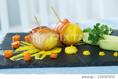 Bacon wrapped potatoes with sauce Bacon wrapped potatoes with sauce 118597052