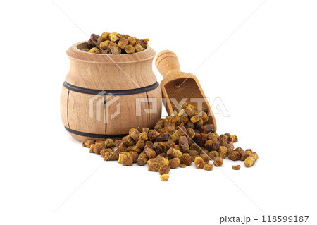 Bee bread in a rustic wooden barrel with a small wooden scoop on white background Bee bread in a rustic wooden barrel with a small wooden scoop on white background 118599187