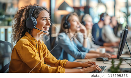 Attractive female customer service agent with headset working in call center Attractive female customer service agent with headset working in call center 118599888