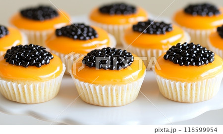 Gourmet delicacy: mini vanilla cupcakes with mango glaze and black caviar Gourmet delicacy: mini vanilla cupcakes with mango glaze and black caviar 118599954
