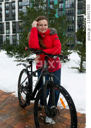 Active European woman in a red jacket rented a bicycle 118601705