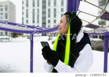 Woman Wearing Scarf Holding Cell Phone Woman Wearing Scarf Holding Cell Phone 118601731