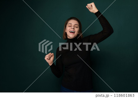 Woman in Black Shirt Holding Arms in the Air 118601863
