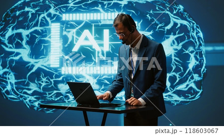 Engineer in artificial intelligence workplace managing call center tasks, speaking into headset. AI company worker chatting with customers through headphones mic, camera A Engineer in artificial intelligence workplace managing call center tasks, speaking into headset. AI company worker chatting with customers through headphones mic, camera A 118603067