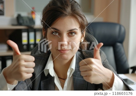 European businesswoman showing thumbs up in her office, success and achievement concept 118603176