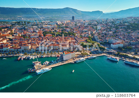 Aerial view of Split, Croatia. Cityscape of coastal touristic city with harbor with mountains in background. Old town with historical red roof tiled buildings near Adriatic Sea 118603764