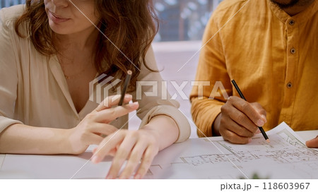 Entrepreneur and real estate agent evaluate investment opportunities by studying blueprints, planning a new high class office layout. Business people meeting realtor financier. Camera A. Entrepreneur and real estate agent evaluate investment opportunities by studying blueprints, planning a new high class office layout. Business people meeting realtor financier. Camera A. 118603967