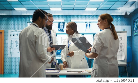 Professional doctors review hospital records and treatment plans in a private clinic to ensure good medical insurance services. Diverse experts analyzing test results for solutions. Camera B. Professional doctors review hospital records and treatment plans in a private clinic to ensure good medical insurance services. Diverse experts analyzing test results for solutions. Camera B. 118604011