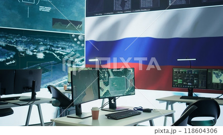 Empty mission control center with the russian flag on big screen, dealing with fake news and a terrorist attack with high tech gear. Spreading misinformation and controlling the people. Camera B. 118604306