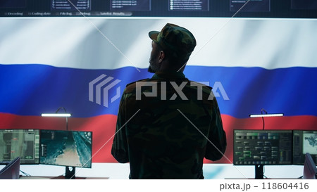 US soldiers working in a top secret operation room with copy space on screen, ensuring national safety while studying surveillance imagery from satellite cctv. Control tower. Camera A. 118604416