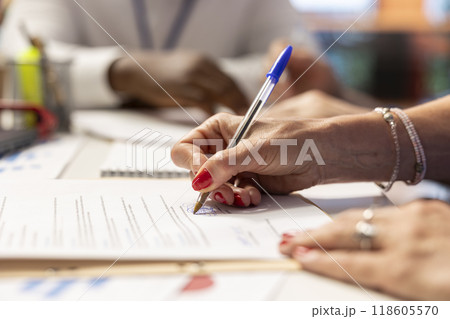 Elderly woman giving her signature on retirement plan contract, choosing the suitable pension option with life insurance policy to secure the future income and family expenses. Close up. 118605570