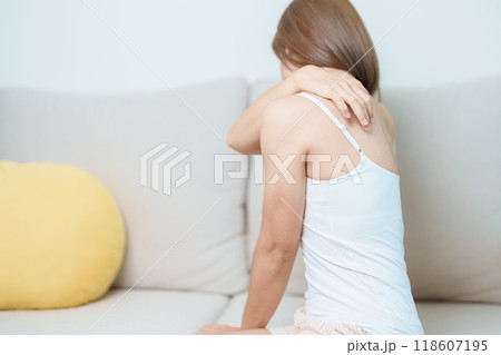 Woman having Shoulder and Neck pain at home. Muscle painful due to Myofascial pain syndrome and Fibromyalgia, rheumatism, Scapular pain, Cervical Spine. ergonomic concept 118607195