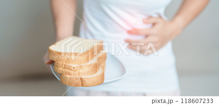 Gluten intolerance, Gluten free and celiac disease or wheat allergy concept. woman hold Bread and having abdominal pain after eat gluten. stomach ache, Nausea, Bloating, Gas, Diarrhea and Skin rash Gluten intolerance, Gluten free and celiac disease or wheat allergy concept. woman hold Bread and having abdominal pain after eat gluten. stomach ache, Nausea, Bloating, Gas, Diarrhea and Skin rash 118607233