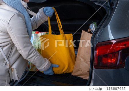 Woman uploading Groceries into Car Woman uploading Groceries into Car 118607485