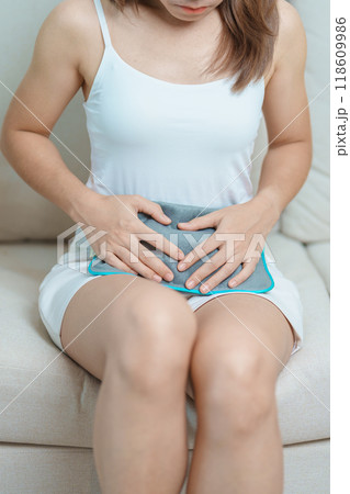 Menstruation period cycle of monthly and Stomachache concepts. woman having abdomen pain and menstrual ache with hot water bottle, illness female suffer from premenstrual ache and body Health problem Menstruation period cycle of monthly and Stomachache concepts. woman having abdomen pain and menstrual ache with hot water bottle, illness female suffer from premenstrual ache and body Health problem 118609986