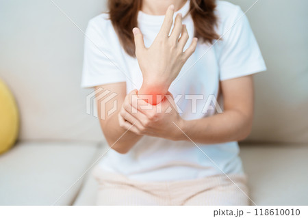 Woman having wrist pain at home, muscle ache due to De Quervain s tenosynovitis, ergonomic, Carpal Tunnel Syndrome or Office syndrome and Parkinson disease concept 118610010