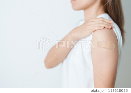 Woman with bandage after receiving vaccine. Vaccination and Immunization for Influenza, HPV, Zoster, IPD, DTP or Diphtheria, Tetanus and Pertussis, MMR, Hepatitis B, Covid  and Varicella vaccine 118610036