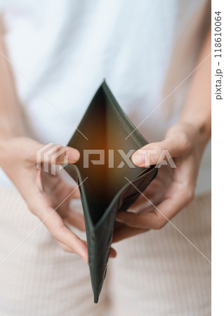 Woman hand holding and open empty wallet with not have banknote money. Crisis, loan, bankrupt and debt financial concept. 118610064
