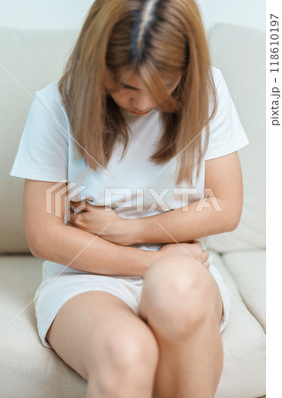 woman having abdomen ache due to Stomach pain, digestion with constipation or Diarrhea from food poisoning, female problem and Endometriosis, Hysterectomy, Stomachache and Menstrual on sofa at home woman having abdomen ache due to Stomach pain, digestion with constipation or Diarrhea from food poisoning, female problem and Endometriosis, Hysterectomy, Stomachache and Menstrual on sofa at home 118610197