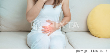 woman having abdomen ache due to Stomach pain, digestion with constipation or Diarrhea from food poisoning, female problem and Endometriosis, Hysterectomy, Stomachache and Menstrual on sofa at home woman having abdomen ache due to Stomach pain, digestion with constipation or Diarrhea from food poisoning, female problem and Endometriosis, Hysterectomy, Stomachache and Menstrual on sofa at home 118610203