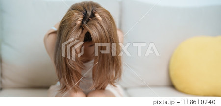 Stress, Sad and unhappy concepts. Alone asian Woman having headache, Young female feeling frustrated, exhausted and suffering Stress, Sad and unhappy concepts. Alone asian Woman having headache, Young female feeling frustrated, exhausted and suffering 118610240