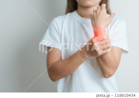 Woman having wrist pain at home, muscle ache due to De Quervain s tenosynovitis, ergonomic, Carpal Tunnel Syndrome or Office syndrome and Parkinson disease concept 118610434