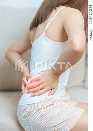 woman having back body ache during at home. adult female with muscle pain due to Piriformis Syndrome, Low Back Pain and Spinal Compression. Office syndrome and medical concept woman having back body ache during at home. adult female with muscle pain due to Piriformis Syndrome, Low Back Pain and Spinal Compression. Office syndrome and medical concept 118611281