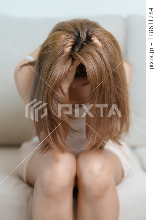 Stress, Sad and unhappy concepts. Alone asian Woman having headache, Young female feeling frustrated, exhausted and suffering Stress, Sad and unhappy concepts. Alone asian Woman having headache, Young female feeling frustrated, exhausted and suffering 118611284