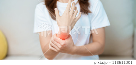 Woman having wrist pain at home, muscle ache due to De Quervain s tenosynovitis, ergonomic, Carpal Tunnel Syndrome or Office syndrome and Parkinson disease concept 118611301