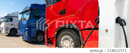 Electric vehicles charging station on a background of a trucks. Concept Electric vehicles charging station on a background of a trucks. Concept 118612571