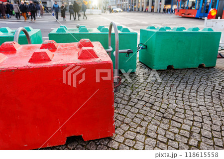 Colorful concrete safety barriers blocks protecting public holiday Christmas market against terror attack attempt. Anti-terror measures in European german city streets Colorful concrete safety barriers blocks protecting public holiday Christmas market against terror attack attempt. Anti-terror measures in European german city streets 118615558