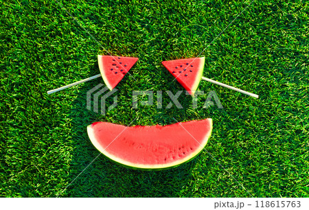 Summer fresh image of lollipop or ice cream shaped slice of watermelon on the grass background Summer fresh image of lollipop or ice cream shaped slice of watermelon on the grass background 118615763