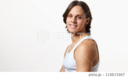 Young man dressed white T-shirt looking at camera with cheerful, healthy wide smile against white studio background. 118615867