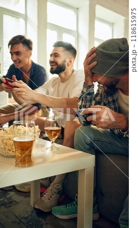 In full swing, everyone's smiles contagious as they compete. Cozy setting with beers and snacks keeps mood friendly and upbeat. In full swing, everyone's smiles contagious as they compete. Cozy setting with beers and snacks keeps mood friendly and upbeat. 118615975