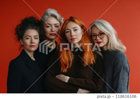 Confident Women Posing Together Against Red Background 118616106