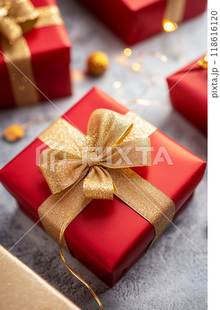Red gift boxes with gold ribbon on gray background 118616120