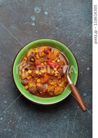 Carbonada Criolla, Argentinian beef casserole stew in bowl with serving spoon top view Carbonada Criolla, Argentinian beef casserole stew in bowl with serving spoon top view 118616305