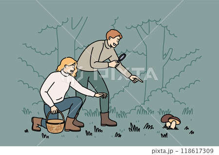 Man and woman are searching for mushrooms in forest using wicker basket and magnifying glass 118617309