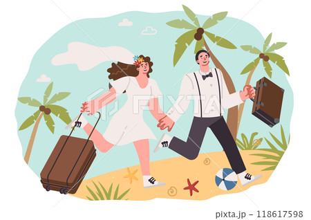 Honeymoon for newlyweds running along beach with luggage in hands, hurrying to swim in sea 118617598