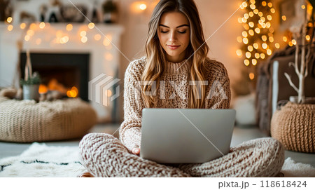 Young Woman Working on Laptop While Sitting Indoors Young Woman Working on Laptop While Sitting Indoors 118618424